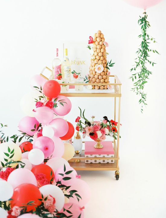 Pile of balloon near a cart with sweets